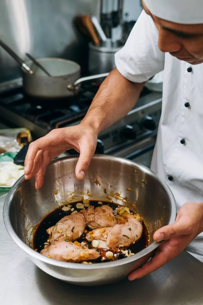 A Photo Of A Man Marinating Chicken In A Leetb59srpsncf2wcvtpqq Ysl186 9q1sbrpj44pqveq